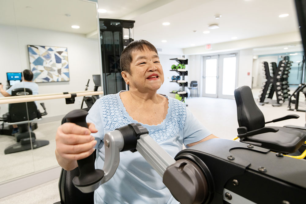 Resident using fitness equipment at Bellingham at West Chester