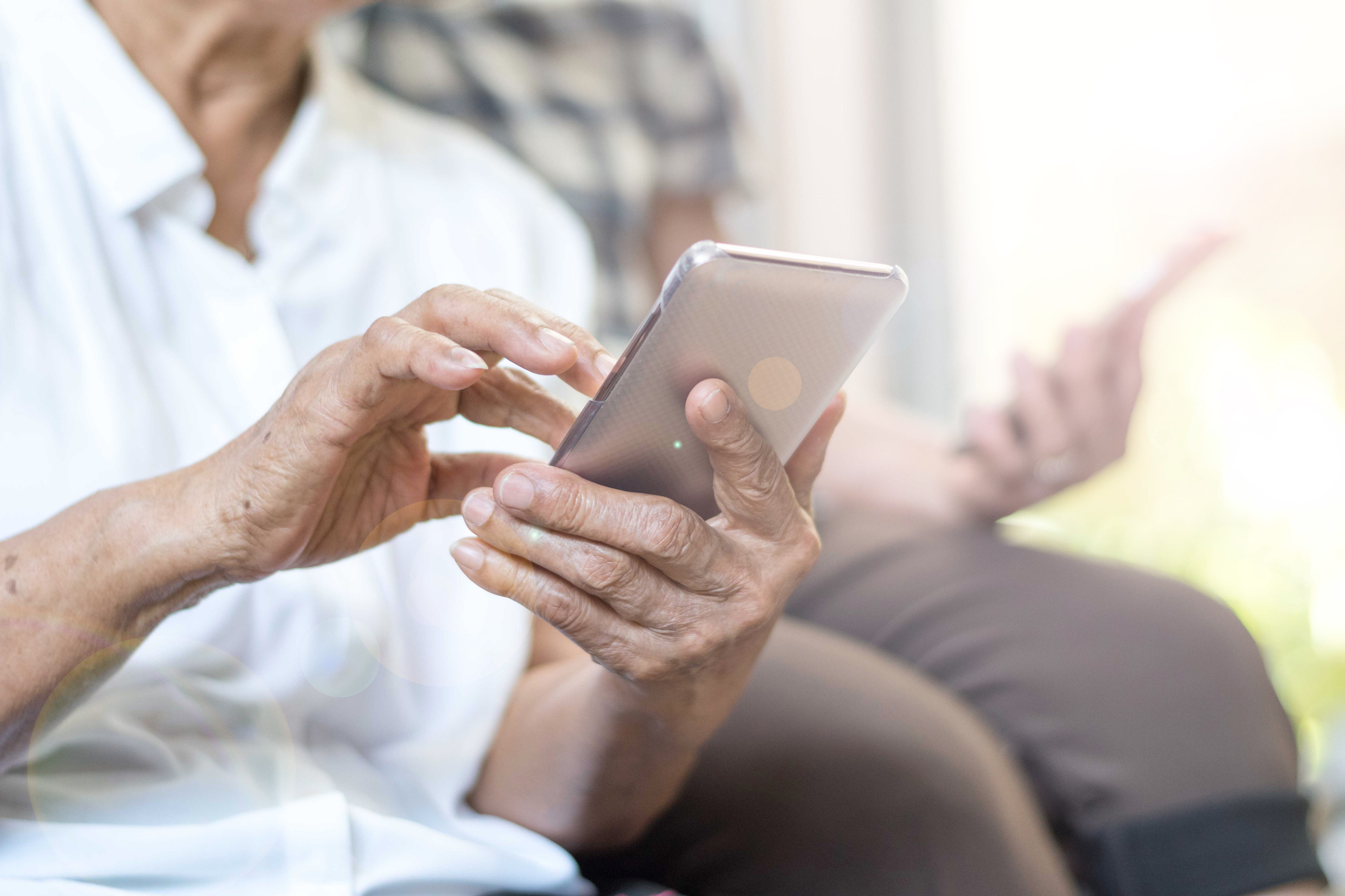 Happy elderly senior people society lifestyle technology concept. Ageing Asia women using tablet smartphone or mobile phone share social media together in wellbeing county home.