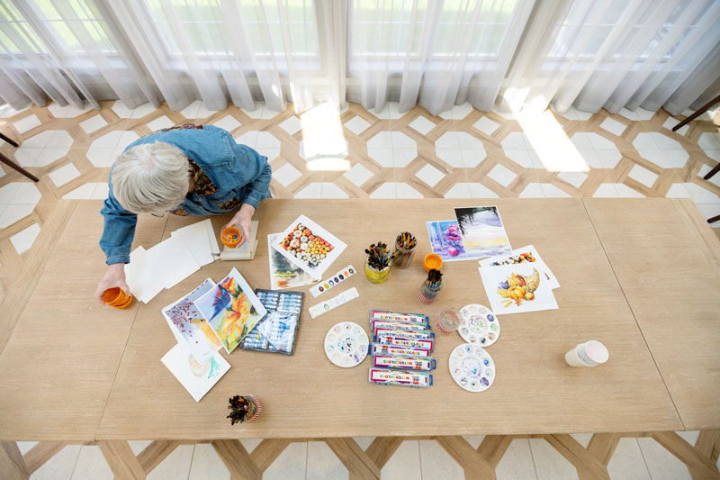 senior woman crafting at a table