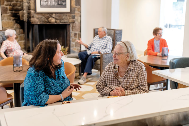Two women chatting in lounge area